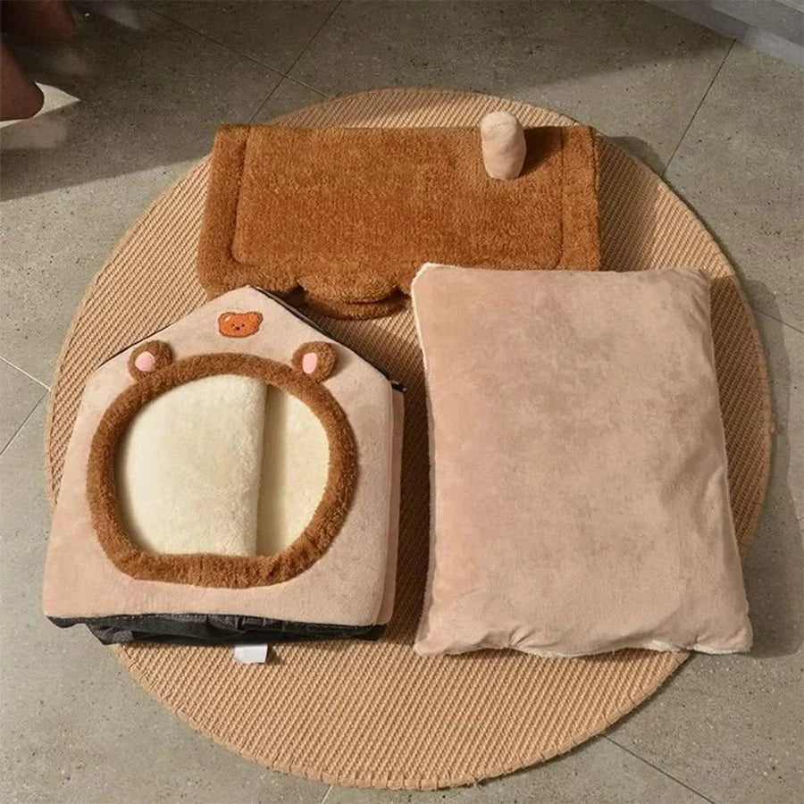 Pet bed with house and cushion design on a textured surface